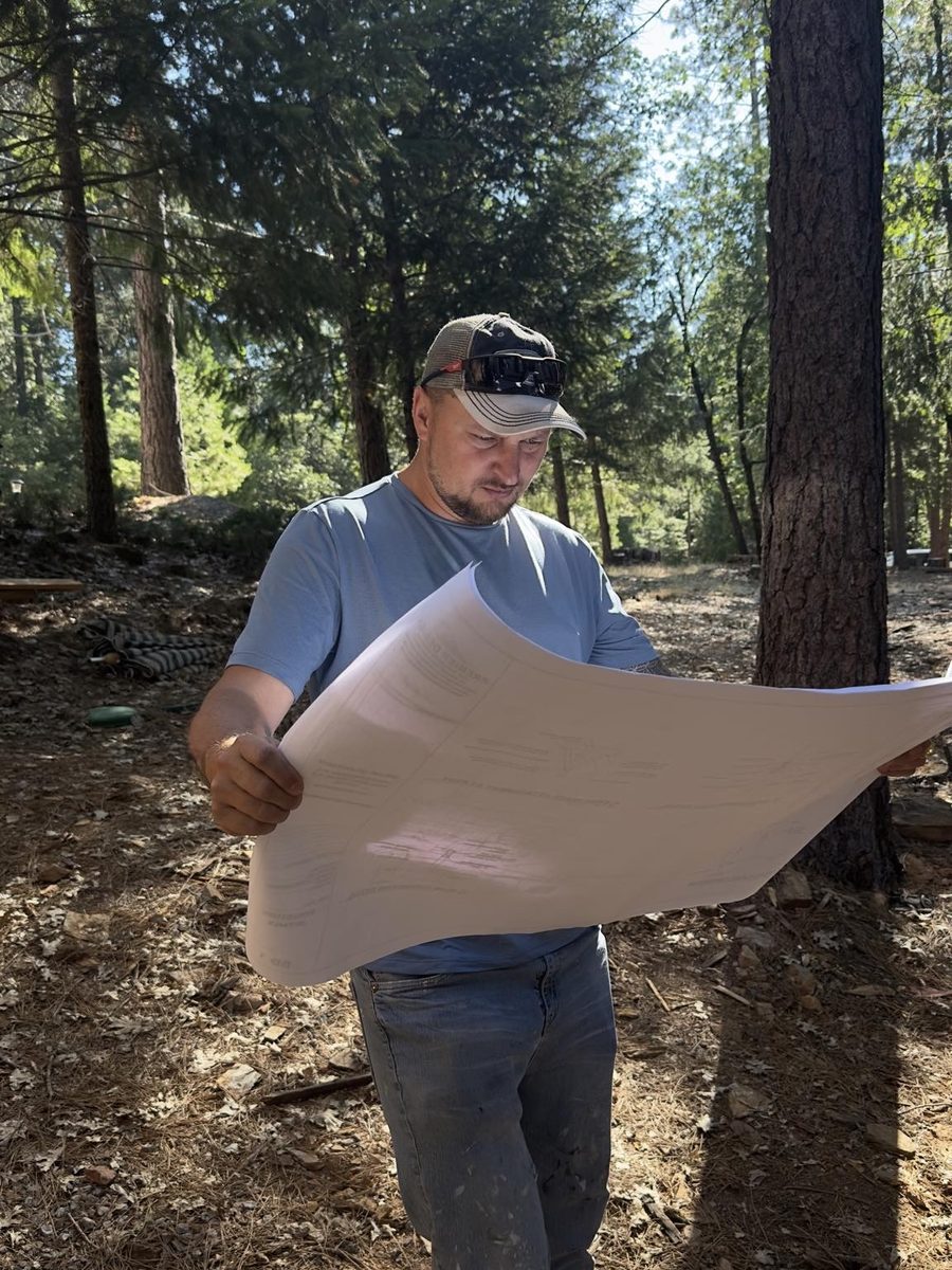 Contractor reviewing a plan set on site before work begins