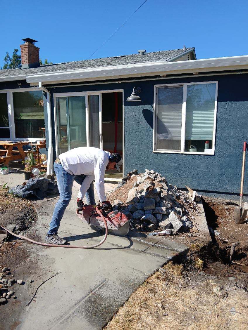Cutting an old concrete walkway with a saw
